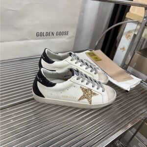 Golden Goose Women's White and Black Sneakers with Gold Star
